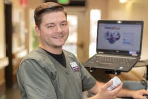 A caregiver at a nurse's cart in the hallway at Crystal Ridge Care Center